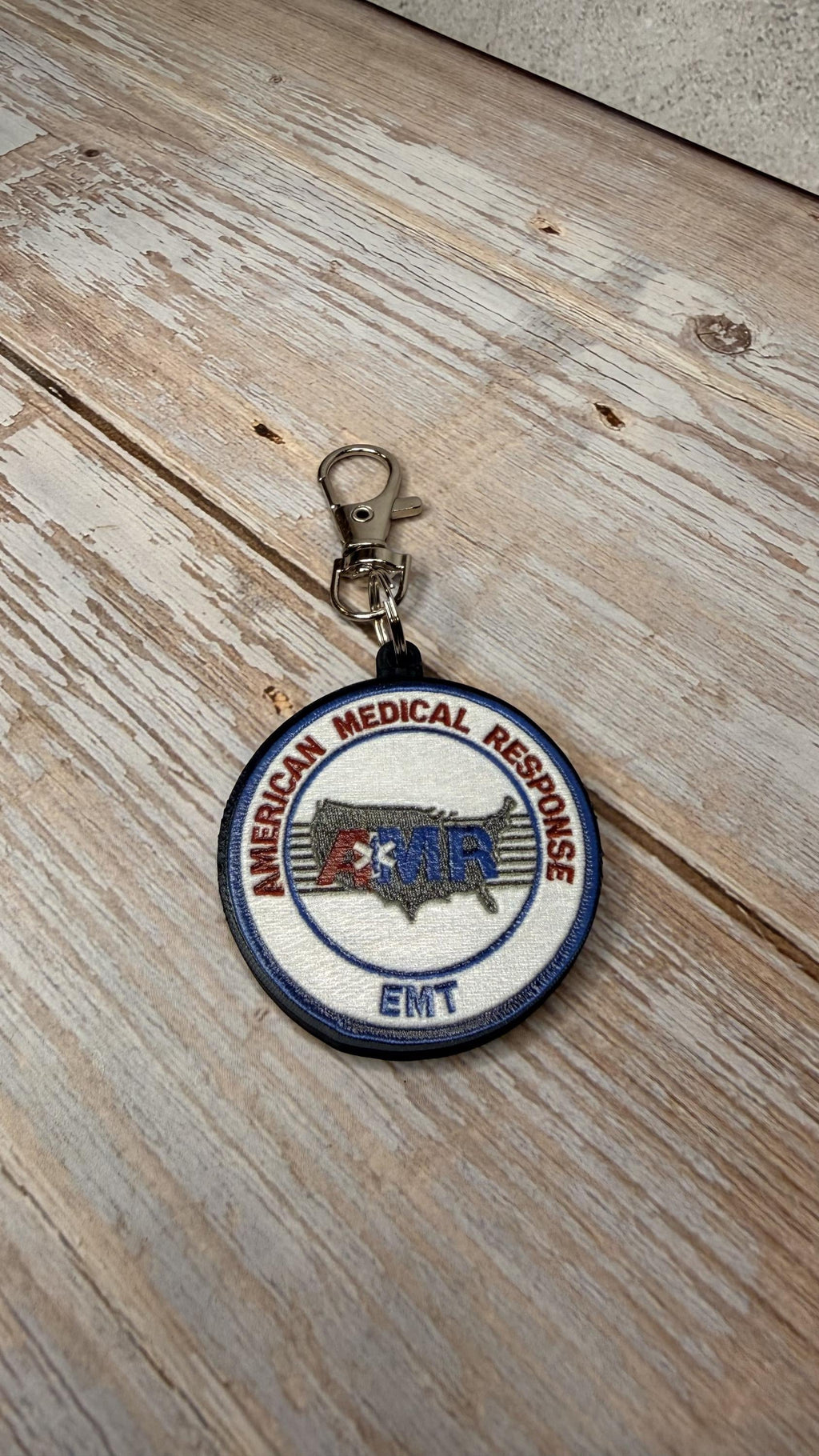 AMR EMT keychain on wood